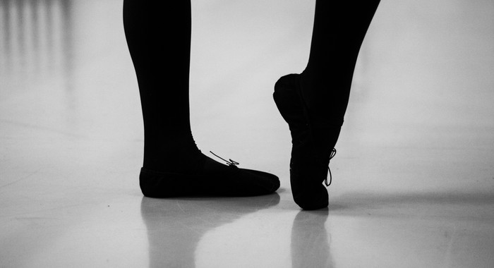 Beine und Füße einer Tänzerin auf dem Tanzboden