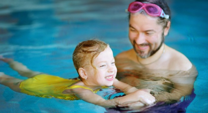 Kleinkind hat Spaß beim Schwimmen.