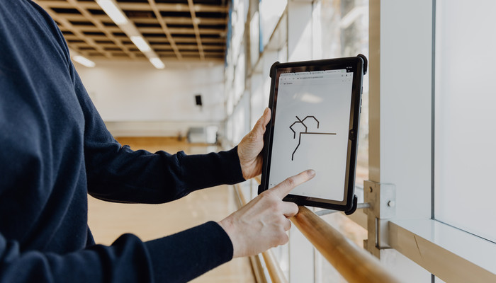 Finger zeigt auf Darstellung einer Figur auf de miPad