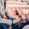 Sportmanager sitzt mit Tablet auf Tribüne ©iStock.com-South_agency