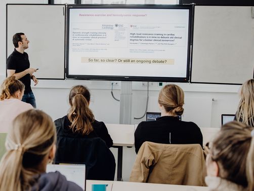 Dozent unterrichtet Studierende im Seminarraum
